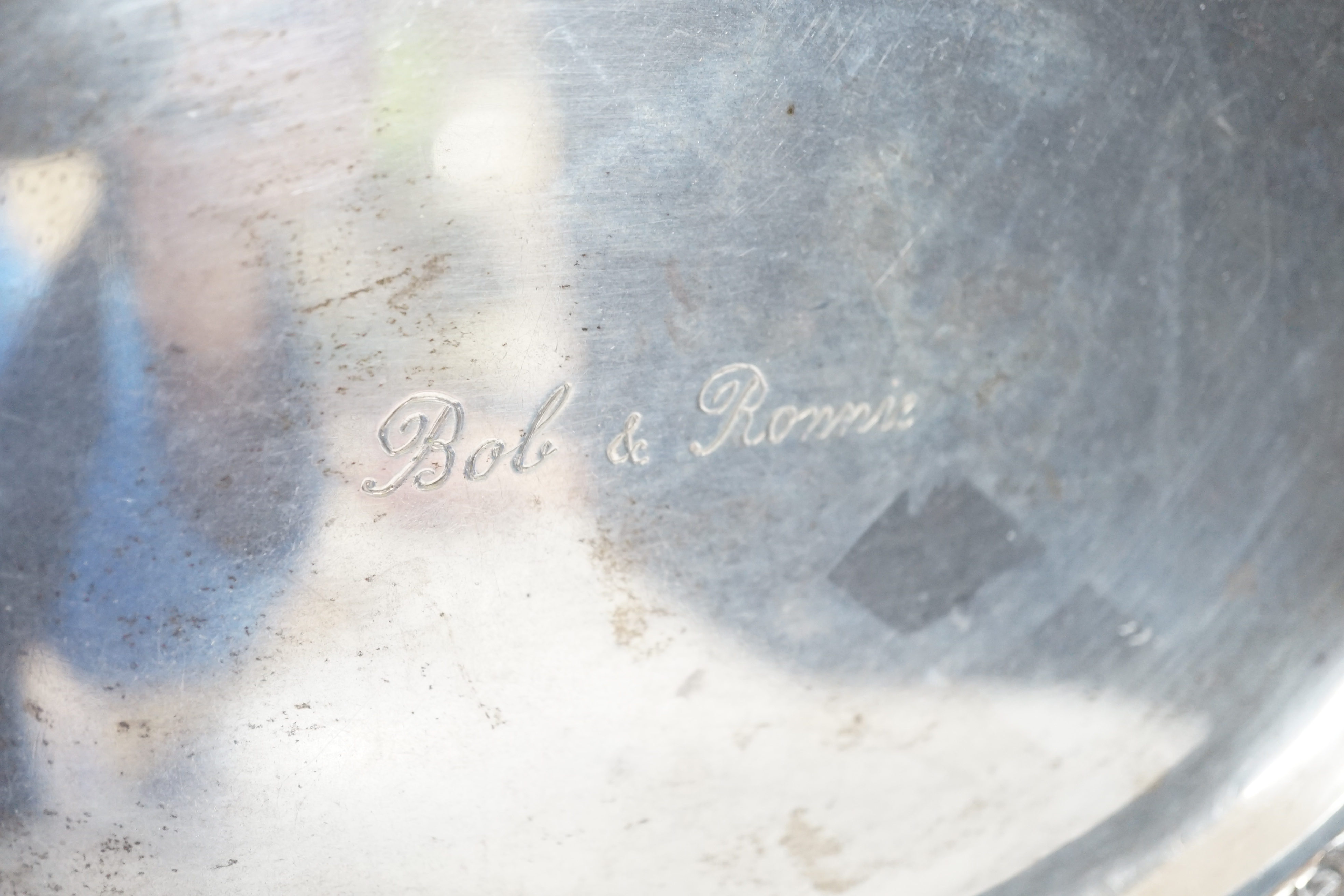 A Thai white metal oval salver, the border decorated with flowers, birds and squirrels, stamped sterling, 31cm